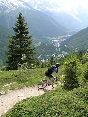 Mountain Bike Guide Riding above the Chamonix Valley, glad that he is not stuck in an office!